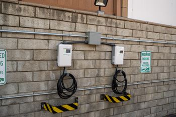 Two electric vehicle charging stations on a wall.